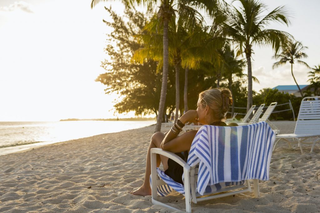 adult woman sitting in beach chair, Grand Cayman Island