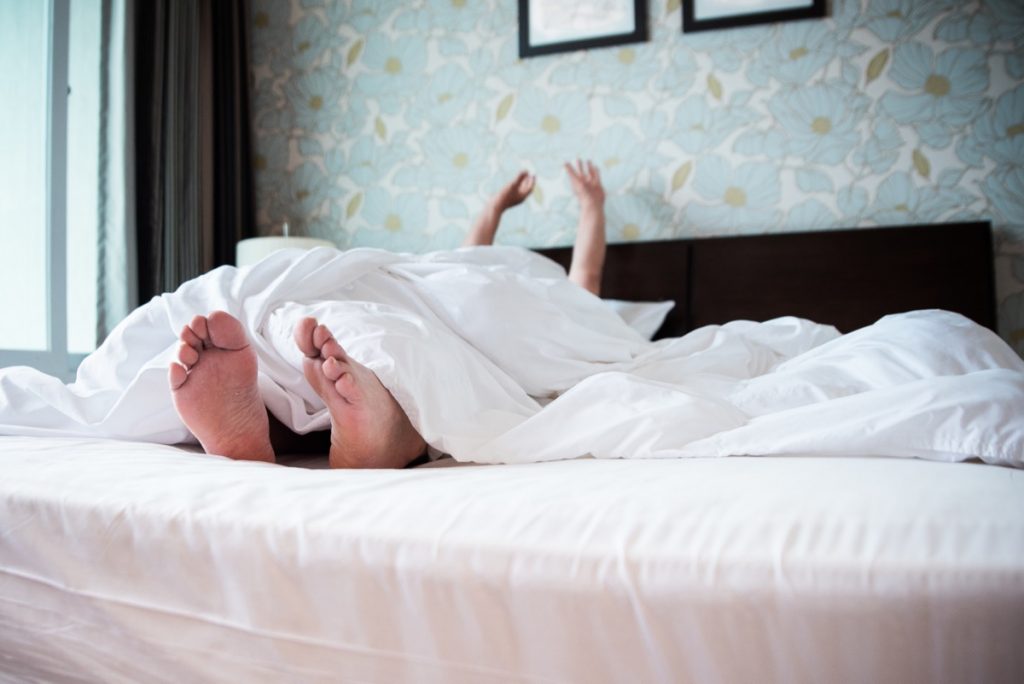 Sleepy woman in a very soft, luxurious bed